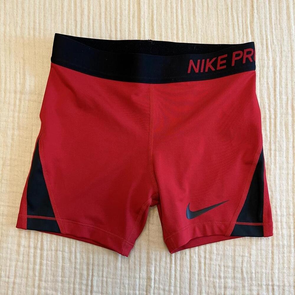Nike Pro compression shorts featuring a red body with color-block black side pan